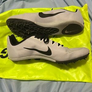 Nike gray track cleats. Worn for one race. Mens’s 9.5.